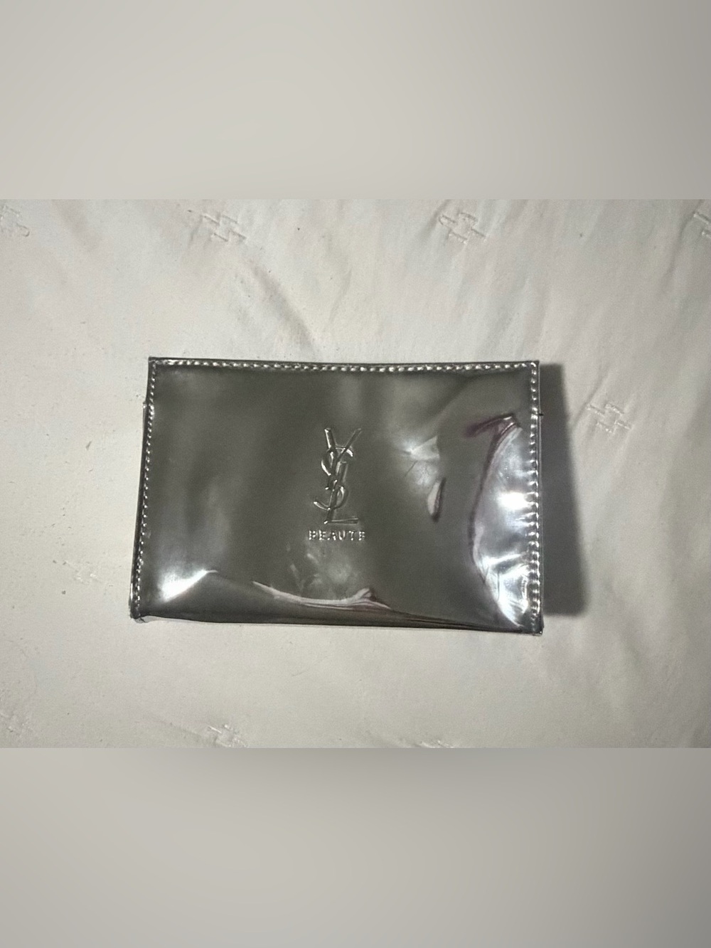 Brand new YSL silver pouch. Dimensions are 7” x 5” x 2”.